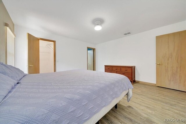 10741 W Pine Bark Ln, Crystal River, FL 34429 - bedroom featuring light wood-style floors and baseboards