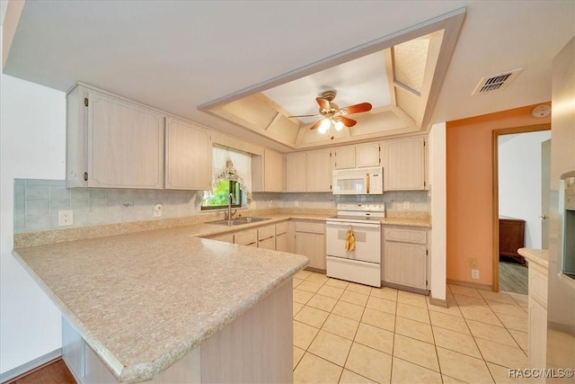 10741 W Pine Bark Ln, Crystal River, FL 34429 - kitchen with white appliances, a raised ceiling, a peninsula, light countertops, and tasteful backsplash
