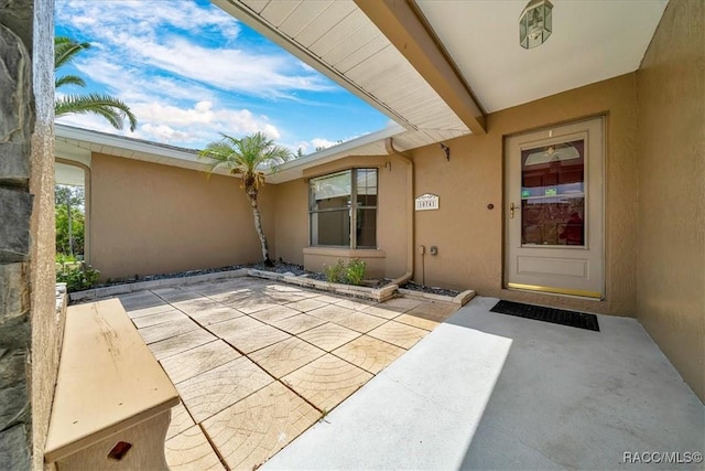 10741 W Pine Bark Ln, Crystal River, FL 34429 - property entrance with stucco siding and a patio
