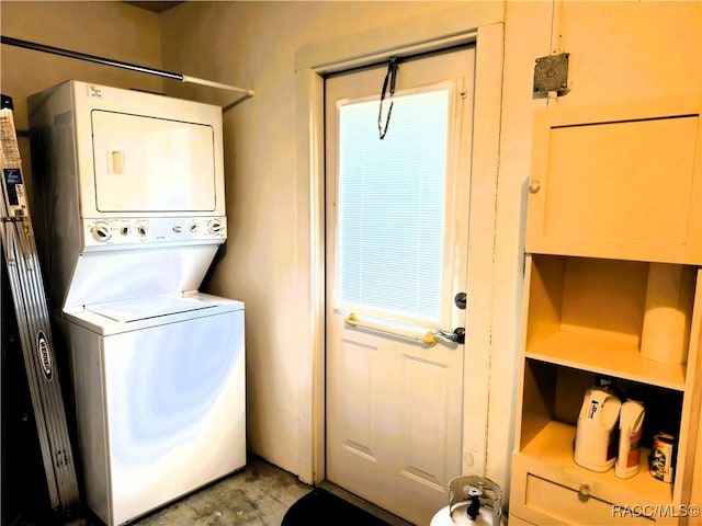 laundry area with stacked washer and clothes dryer