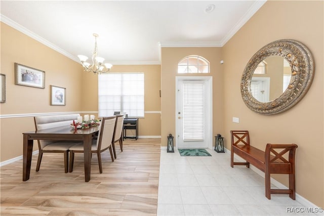 foyer with crown molding, baseboards, and a chandelier