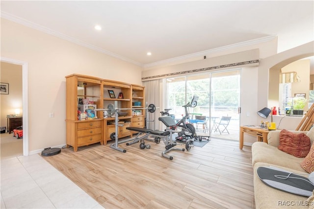 exercise area with arched walkways, light wood-type flooring, baseboards, ornamental molding, and recessed lighting