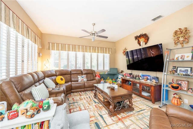 living area with visible vents and a ceiling fan