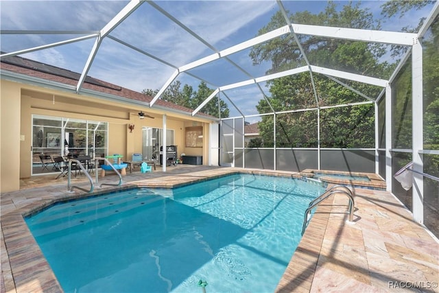view of swimming pool with a patio, ceiling fan, and a pool with connected hot tub