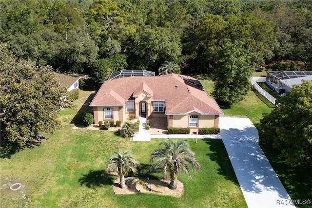 birds eye view of property with a forest view