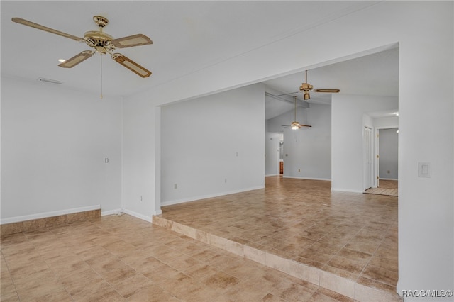 spare room featuring lofted ceiling, ceiling fan, visible vents, and baseboards