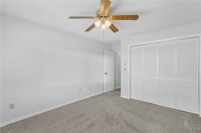 unfurnished bedroom featuring visible vents, baseboards, ceiling fan, carpet floors, and a closet