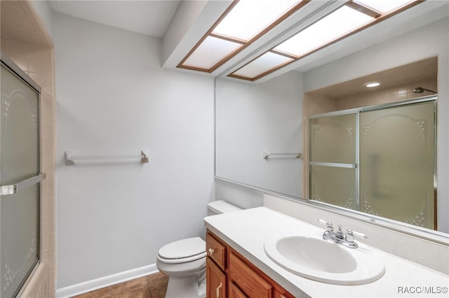 full bath with toilet, tile patterned floors, baseboards, and vanity