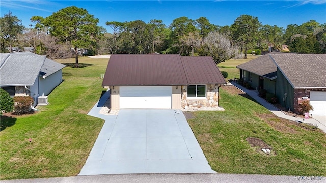 ranch-style house featuring concrete driveway, a front yard, metal roof, a garage, and stone siding