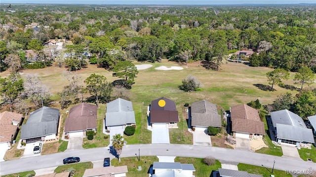 aerial view featuring a forest view and a residential view