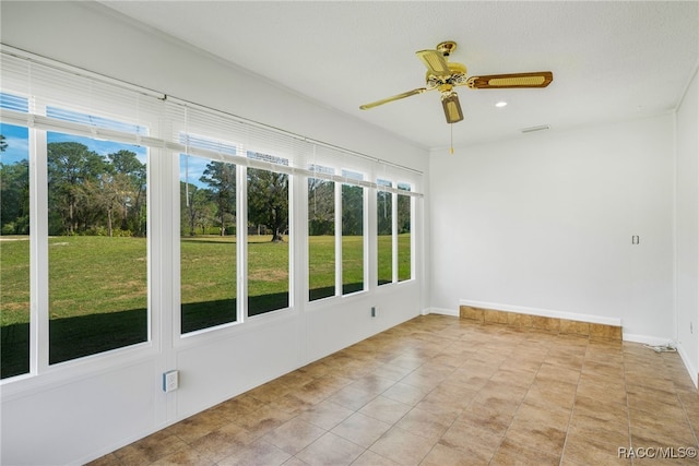 unfurnished sunroom featuring ceiling fan and visible vents