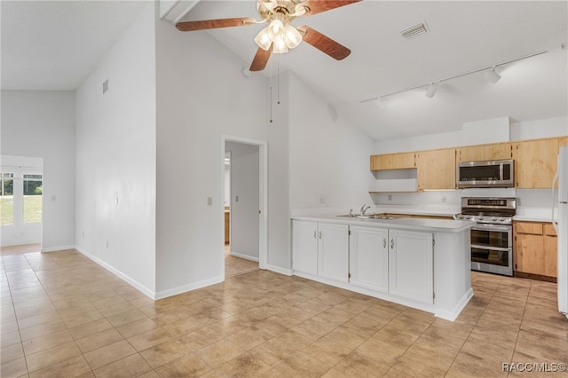 kitchen featuring light countertops, visible vents, appliances with stainless steel finishes, a sink, and baseboards