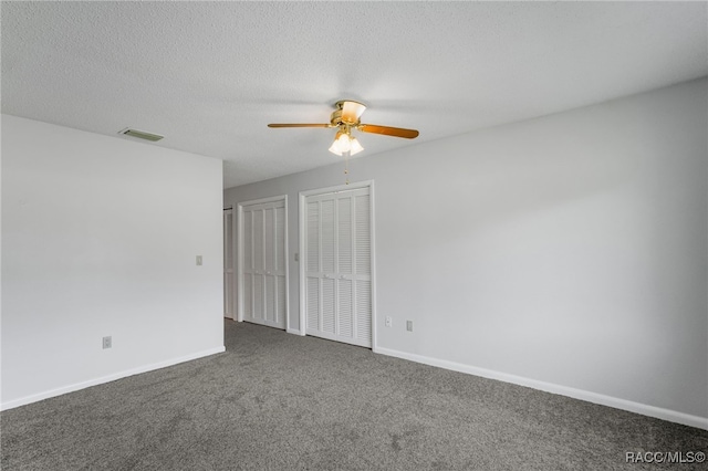 carpeted spare room featuring visible vents, ceiling fan, a textured ceiling, and baseboards