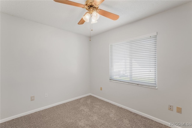 unfurnished room with carpet floors, baseboards, and a ceiling fan