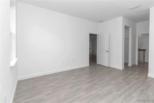 7858 N Merrimac Way, Citrus Springs, FL 34434 - unfurnished bedroom featuring light wood-type flooring and baseboards