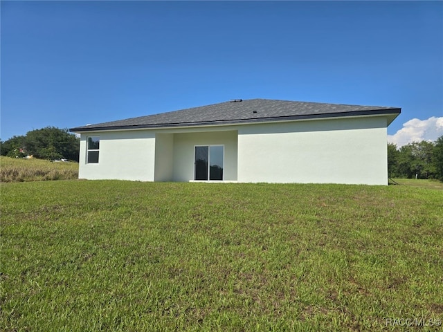 7858 N Merrimac Way, Citrus Springs, FL 34434 - rear view of property featuring a lawn and stucco siding