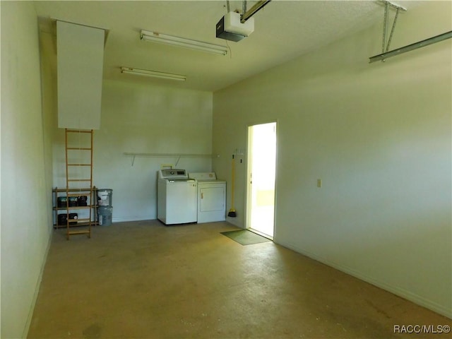 garage featuring washing machine and dryer and a garage door opener