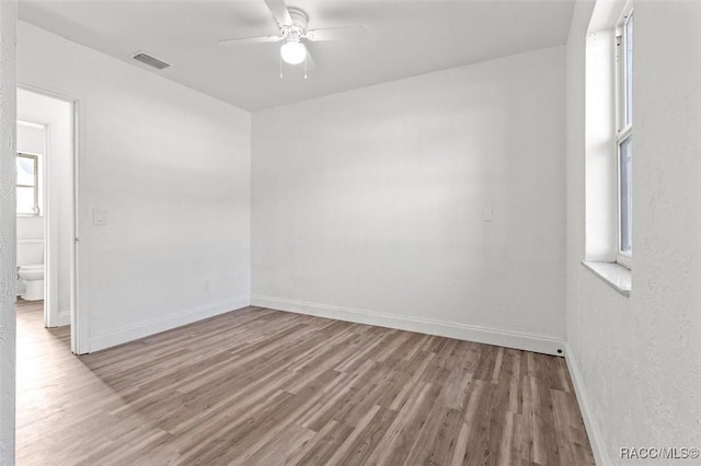 unfurnished room featuring ceiling fan and light wood-type flooring