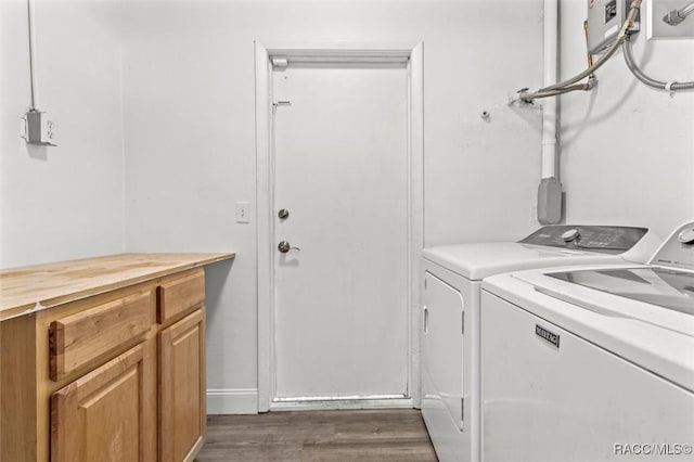 washroom with cabinets, dark hardwood / wood-style floors, and washing machine and dryer