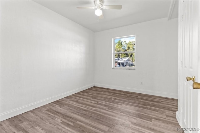 spare room with ceiling fan and wood-type flooring