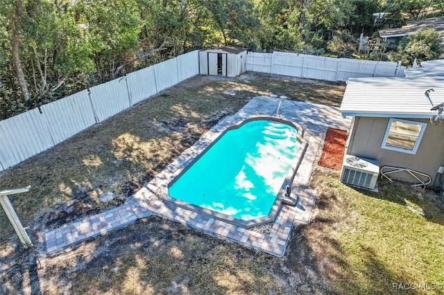 view of swimming pool featuring a patio area and a storage unit