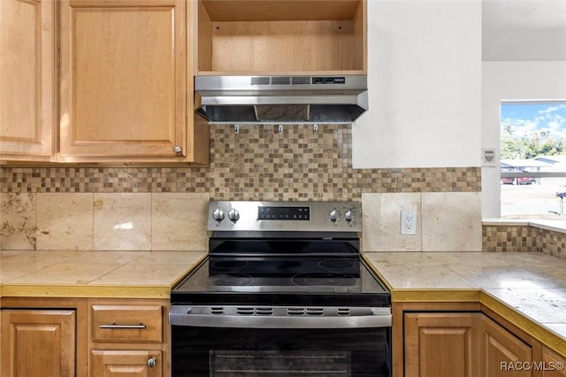 kitchen with tile countertops, tasteful backsplash, stainless steel electric stove, and exhaust hood