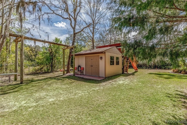 view of outdoor structure with an outbuilding and fence