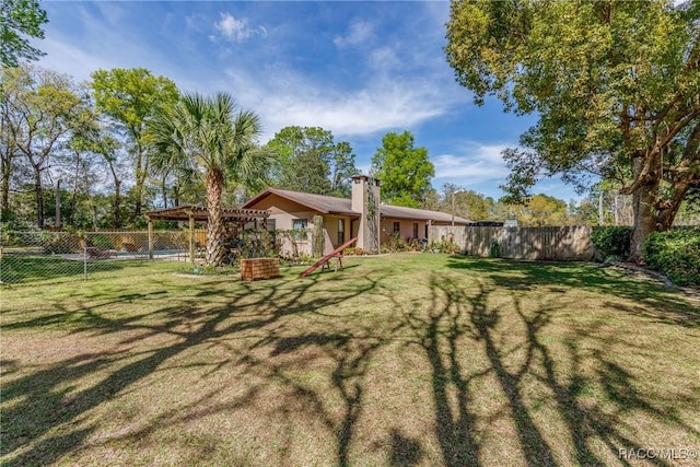 view of yard featuring a fenced backyard and a pergola