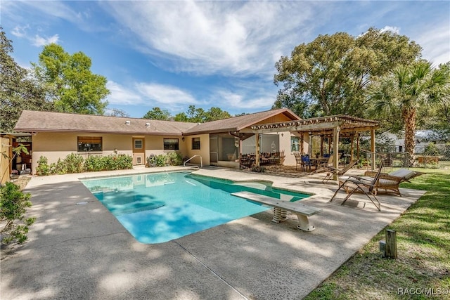 back of property featuring a patio area, an outdoor pool, and stucco siding