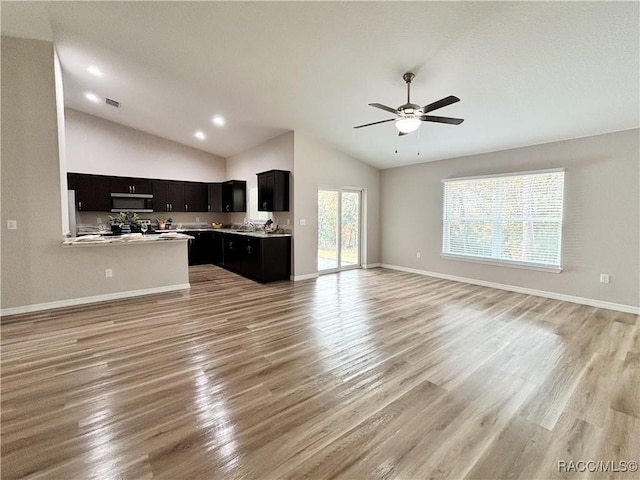 6431 SW 145th Ln, Ocala, FL 34473 - unfurnished living room featuring lofted ceiling, light wood-style flooring, and a ceiling fan
