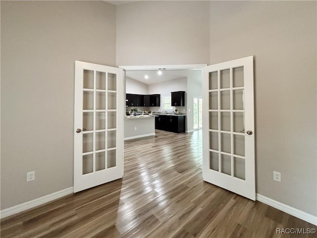 6431 SW 145th Ln, Ocala, FL 34473 - unfurnished room featuring wood finished floors, high vaulted ceiling, and french doors