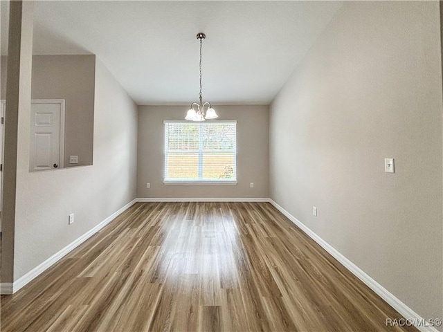 6431 SW 145th Ln, Ocala, FL 34473 - unfurnished dining area with wood finished floors and a chandelier