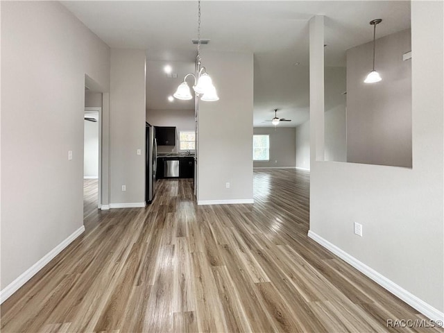 6431 SW 145th Ln, Ocala, FL 34473 - unfurnished dining area featuring ceiling fan, wood finished floors, and a chandelier