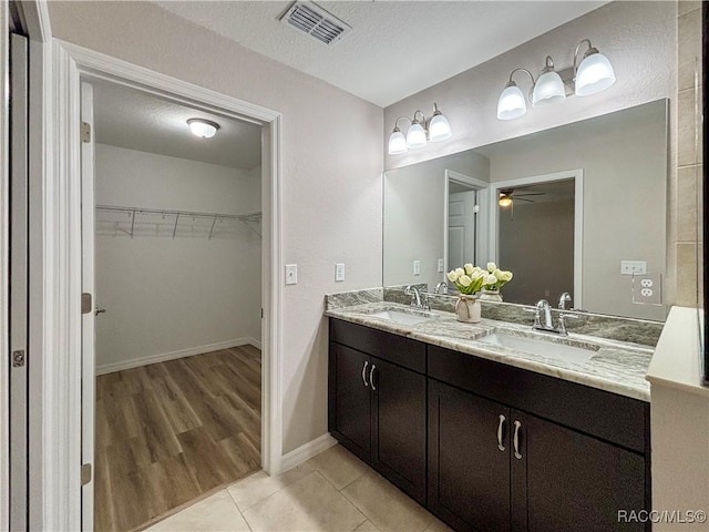 6431 SW 145th Ln, Ocala, FL 34473 - bathroom with double vanity, a ceiling fan, a spacious closet, and tile patterned floors
