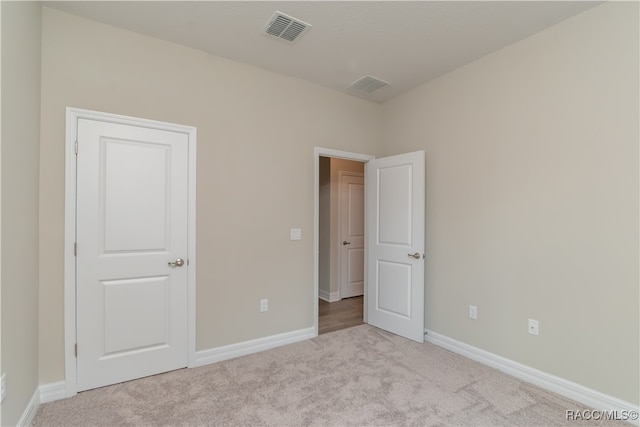 unfurnished bedroom featuring light colored carpet