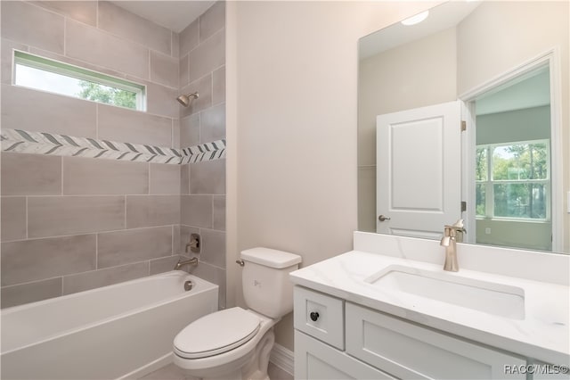 full bathroom with tiled shower / bath combo, toilet, and vanity