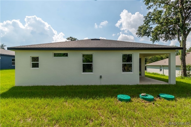 view of side of home with a yard and a patio