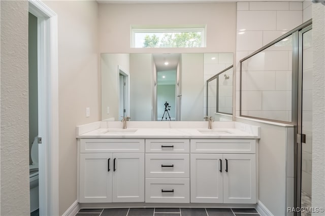 bathroom featuring tile patterned floors, vanity, and an enclosed shower