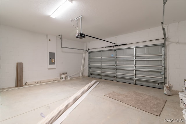 garage with electric panel and a garage door opener