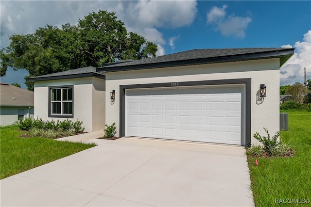 view of front of home with central AC and a garage