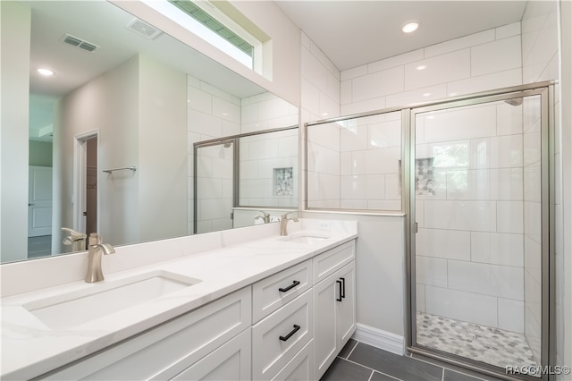 bathroom with tile patterned floors, vanity, and a shower with shower door