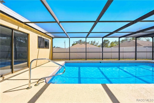 view of swimming pool featuring a patio area, a lanai, and a fenced in pool