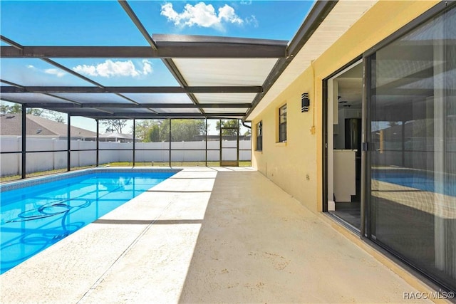 view of swimming pool featuring a fenced backyard, a patio area, a fenced in pool, and glass enclosure