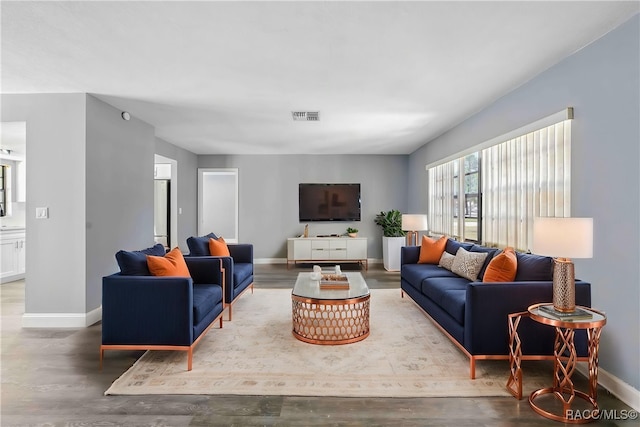 living room featuring visible vents and baseboards