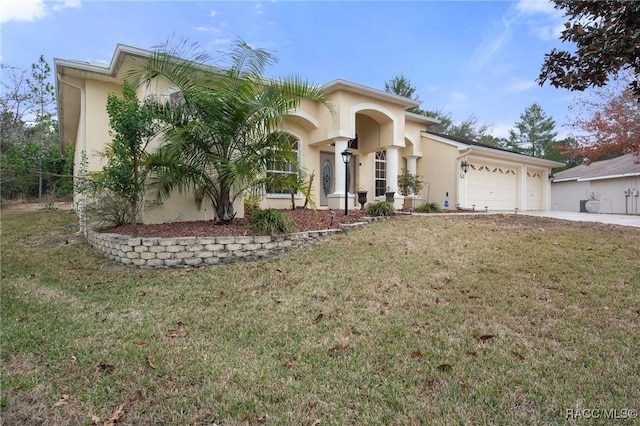 view of front of home featuring a garage and a front lawn