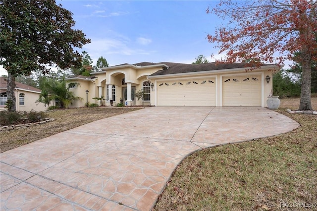 view of front of property with a front yard and a garage