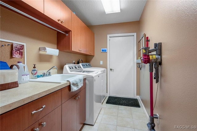 laundry room with washing machine and dryer, sink, and cabinets