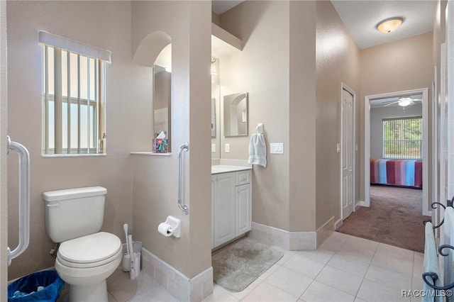 bathroom with ceiling fan, tile patterned floors, vanity, and toilet