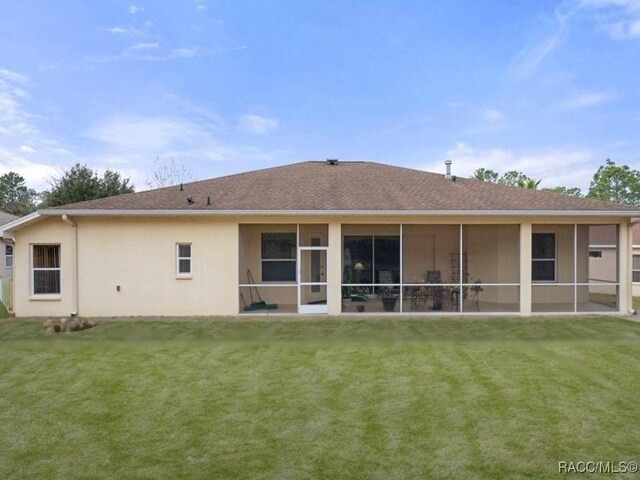 rear view of house featuring a sunroom