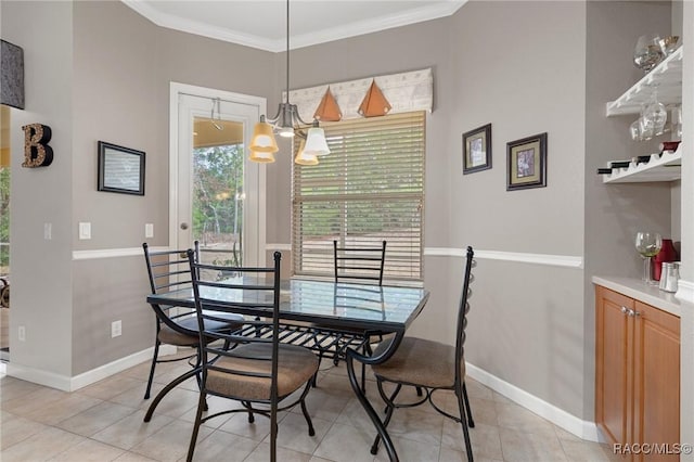 tiled dining space with crown molding and an inviting chandelier